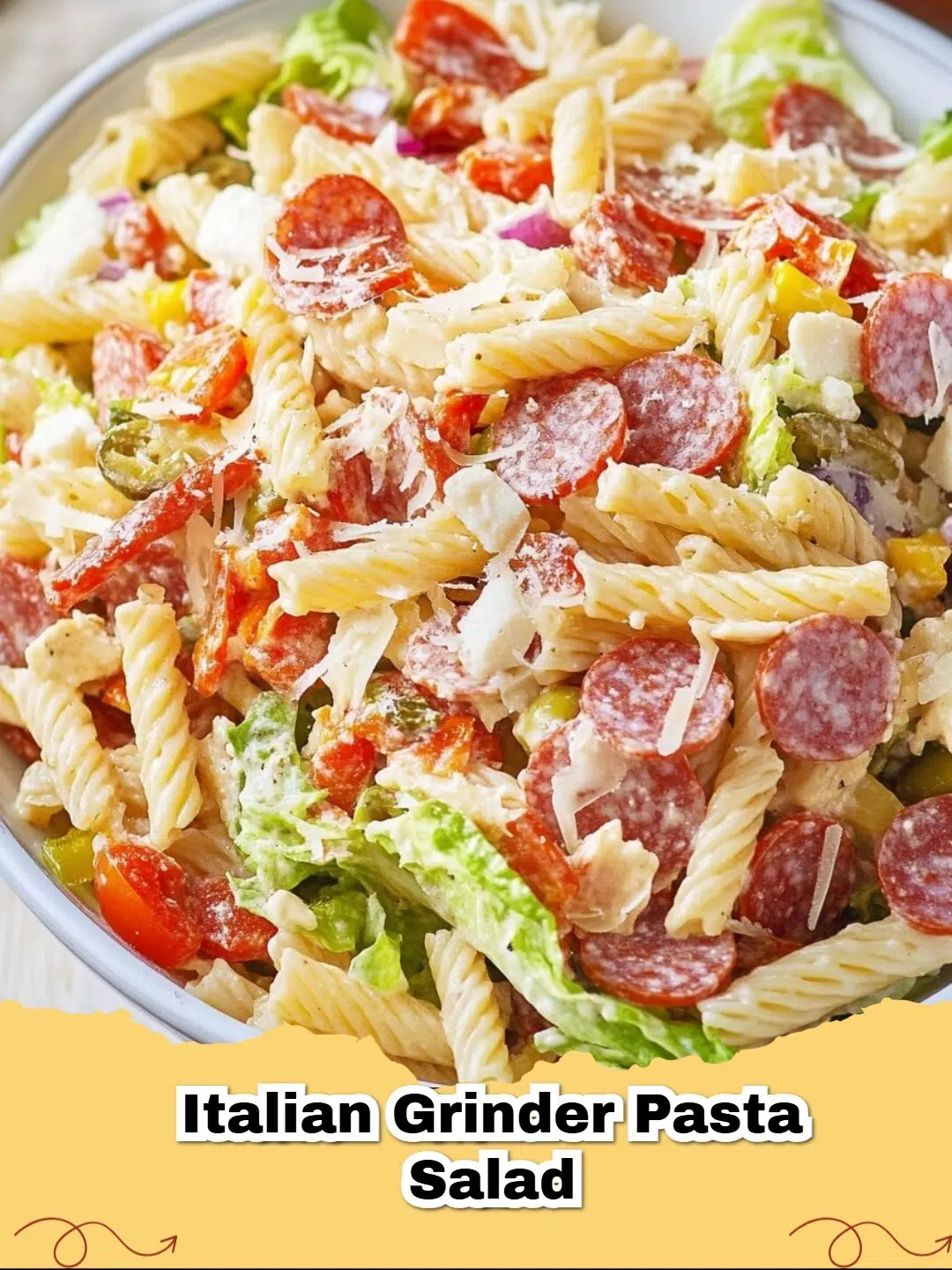 Delicious and vibrant Italian Grinder Pasta Salad in a large serving bowl, garnished with fresh parsley.
