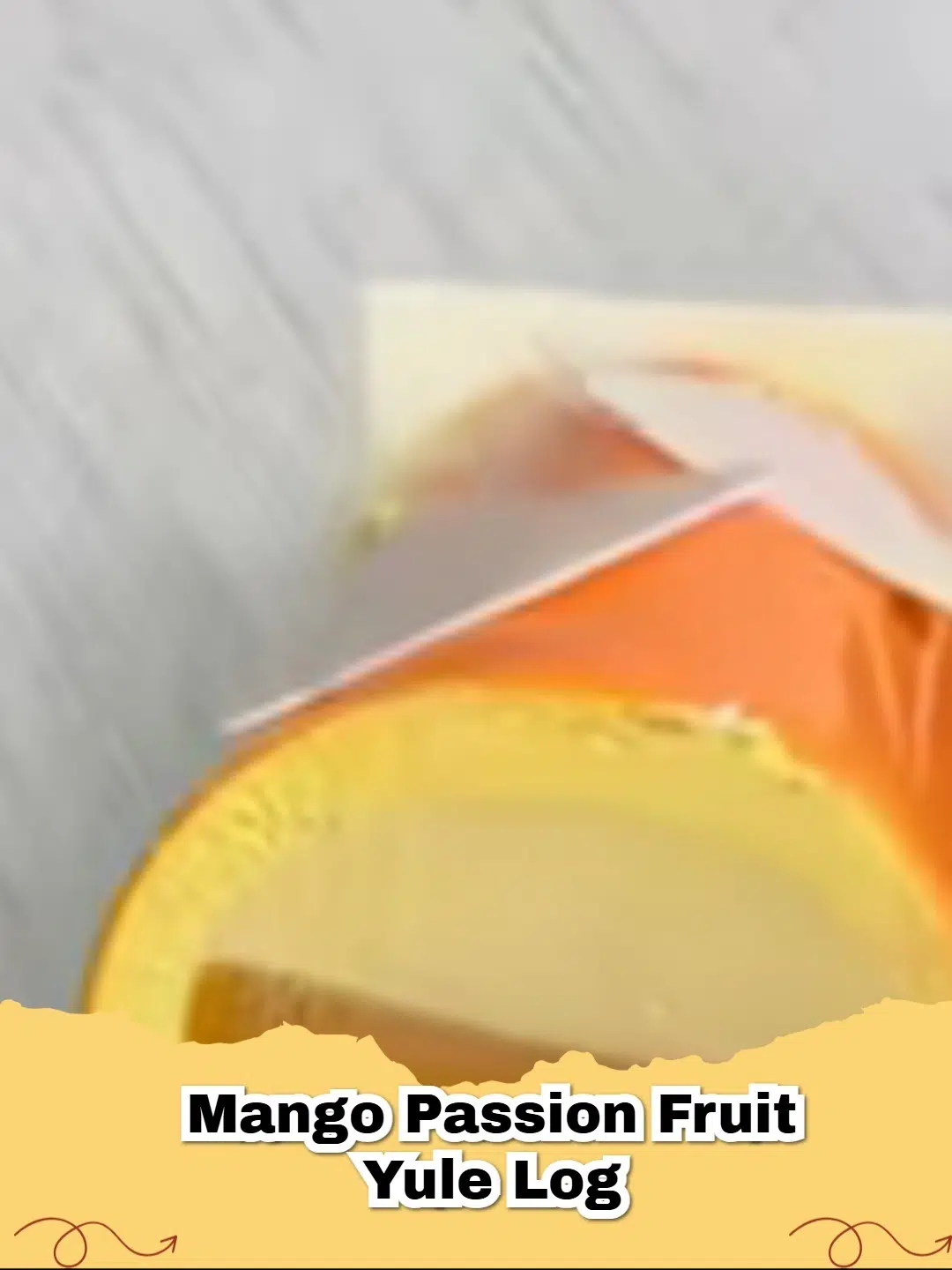 Vibrant Mango Passion Fruit Yule Log garnished with fresh mango and passion fruit seeds, perfect for a tropical holiday dessert.