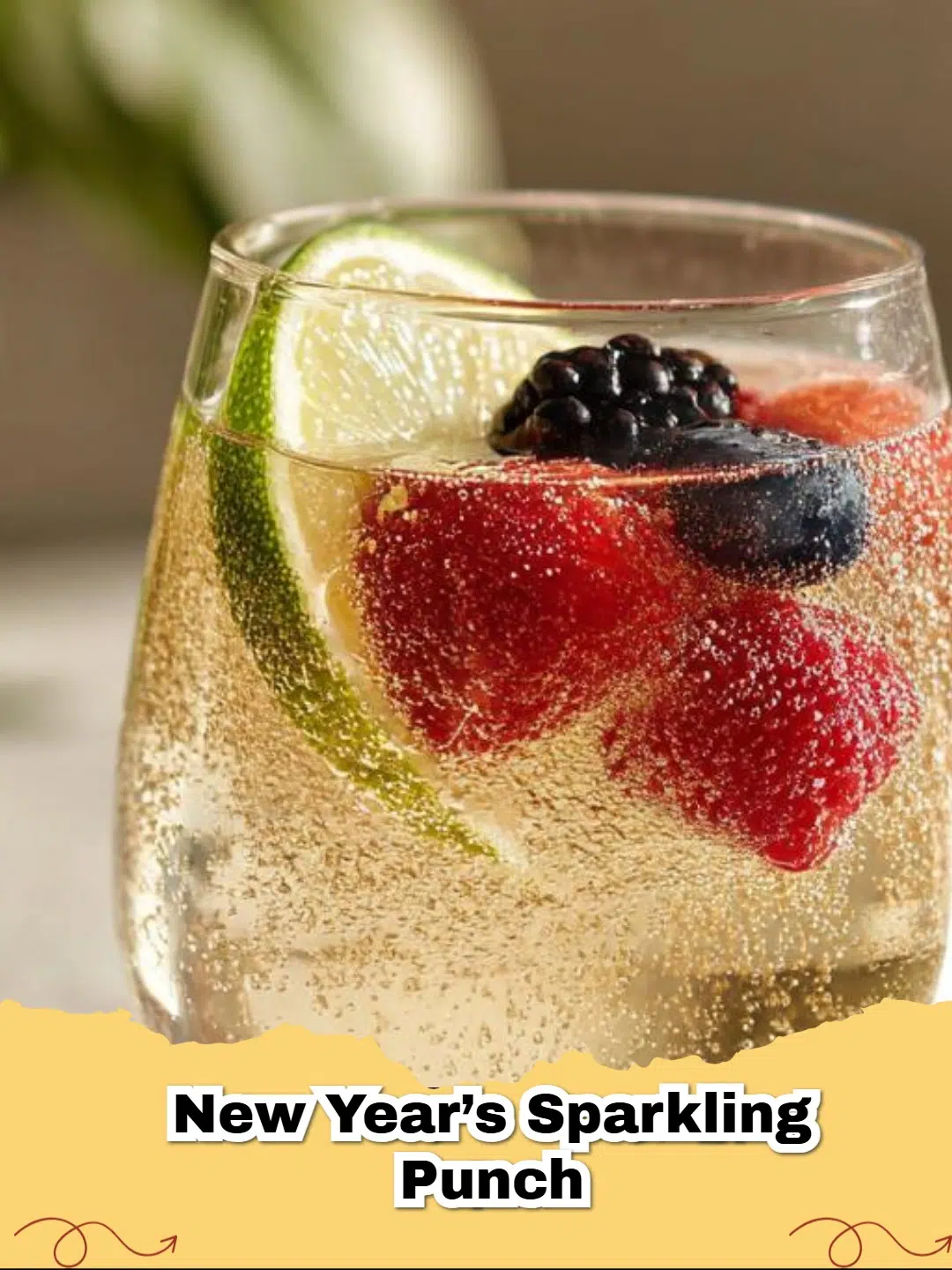 Vibrant New Year's Non-Alcoholic Sparkling Punch in a glass punch bowl with fresh berries and lime slices, ready for celebration.