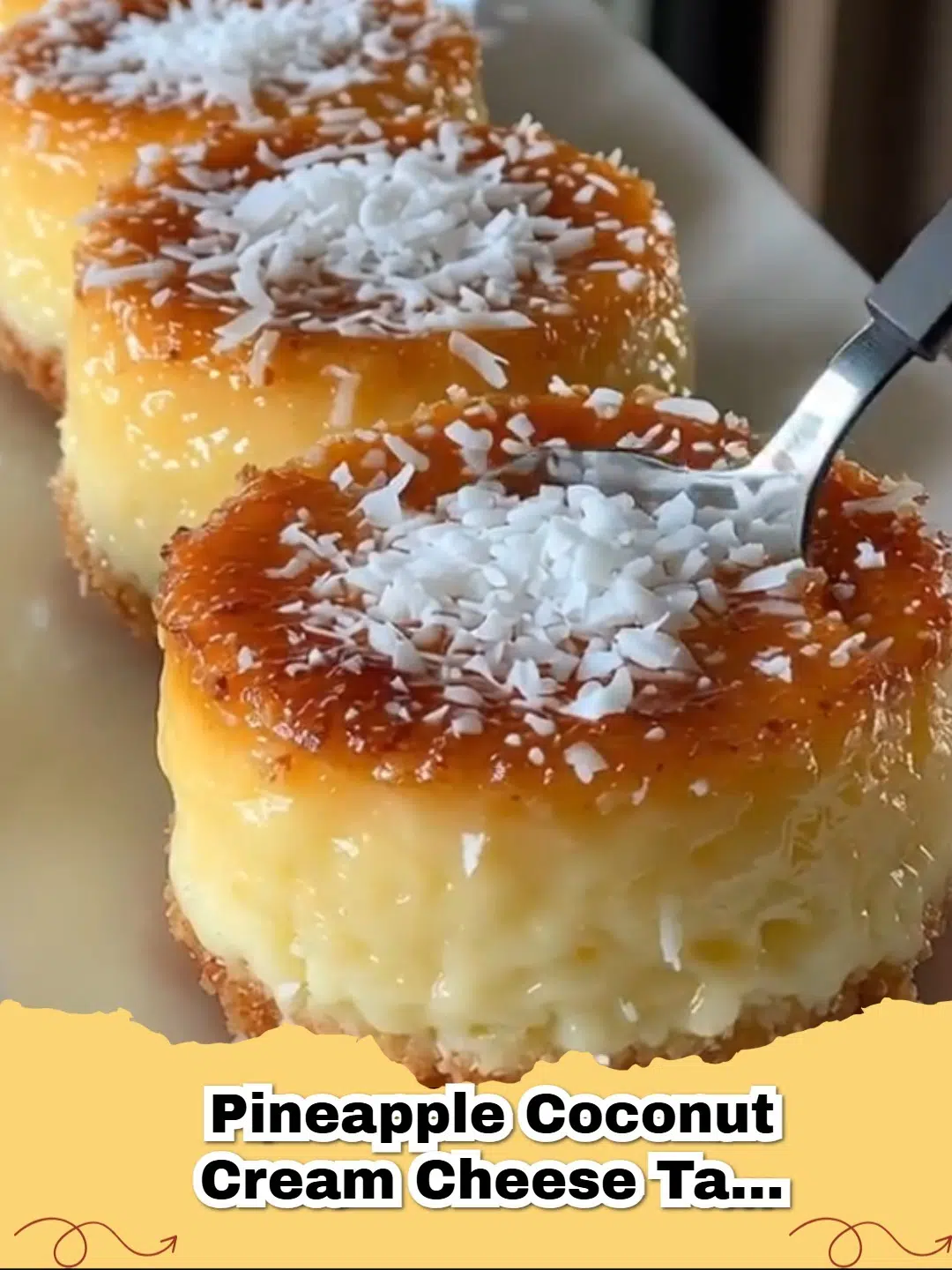 Delicious Pineapple Coconut Cheesecake Tarts garnished with whipped cream and toasted coconut, perfect for a summer dessert.