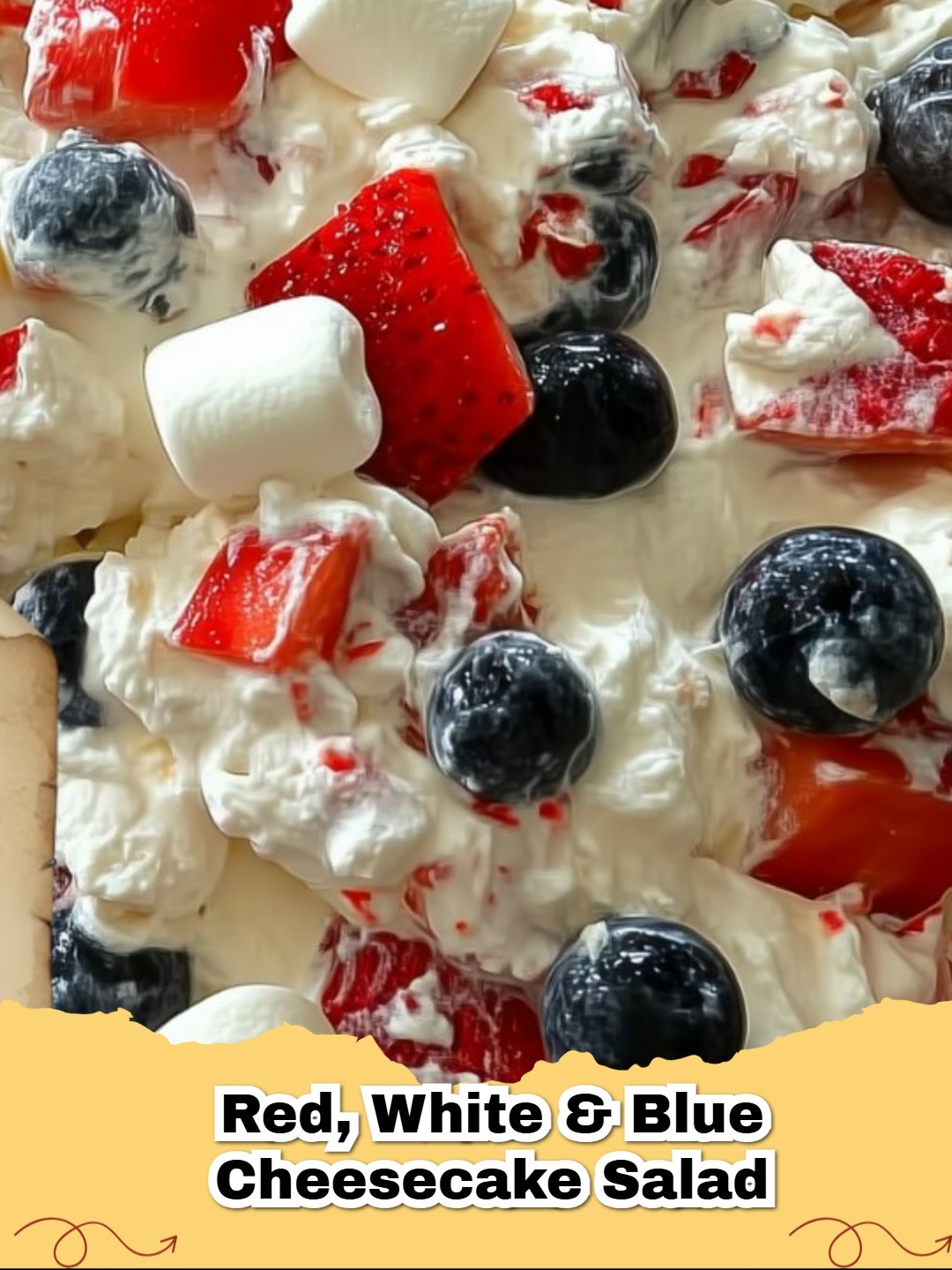 A vibrant bowl of Red, White & Blue No-Bake Cheesecake Salad, with fresh strawberries, blueberries, and fluffy white cream, perfect for summer.