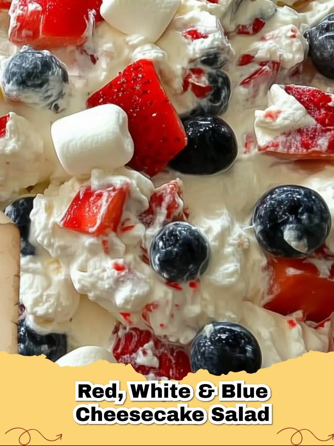 A vibrant bowl of Red, White & Blue No-Bake Cheesecake Salad, with fresh strawberries, blueberries, and fluffy white cream, perfect for summer.