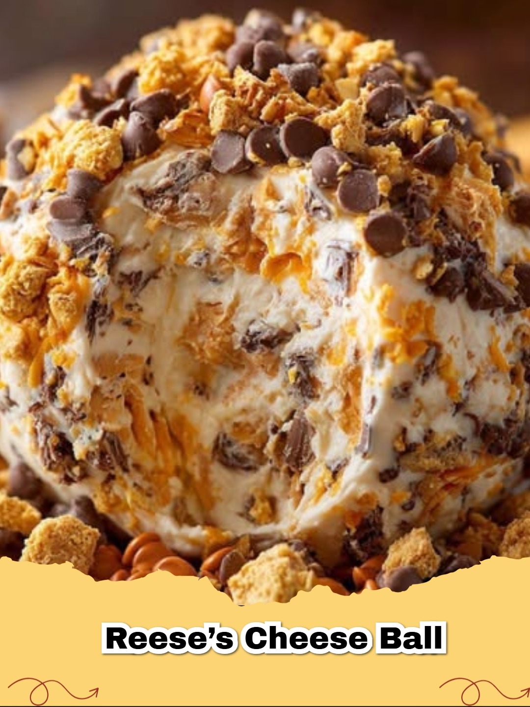 A delightful Reese's Peanut Butter No-Bake Dessert Cheese Ball covered in chopped Reese's cups and chocolate chips, served with dippers.