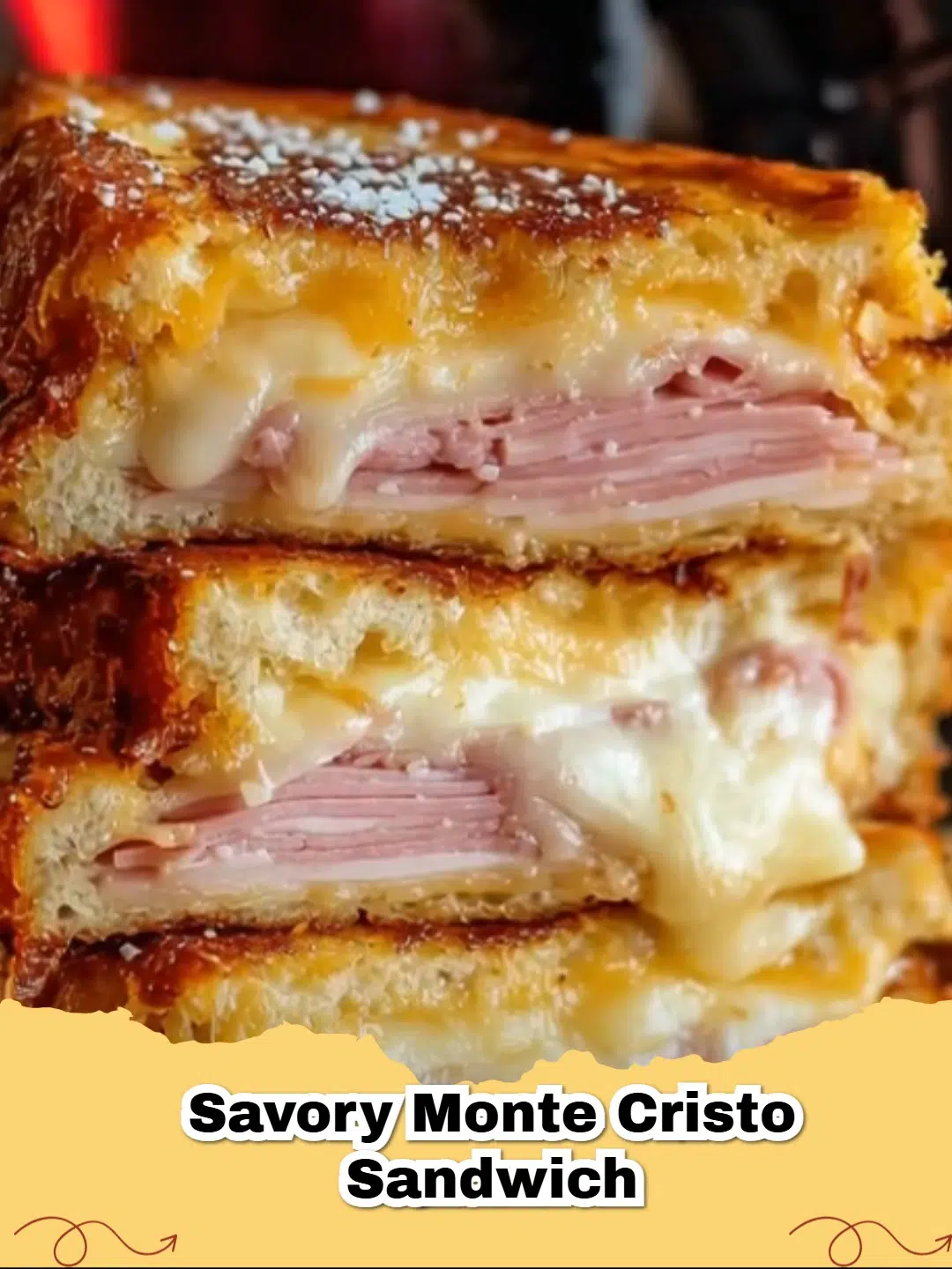 Golden brown savory Monte Cristo sandwich with powdered sugar on top, served with a side of raspberry jam.