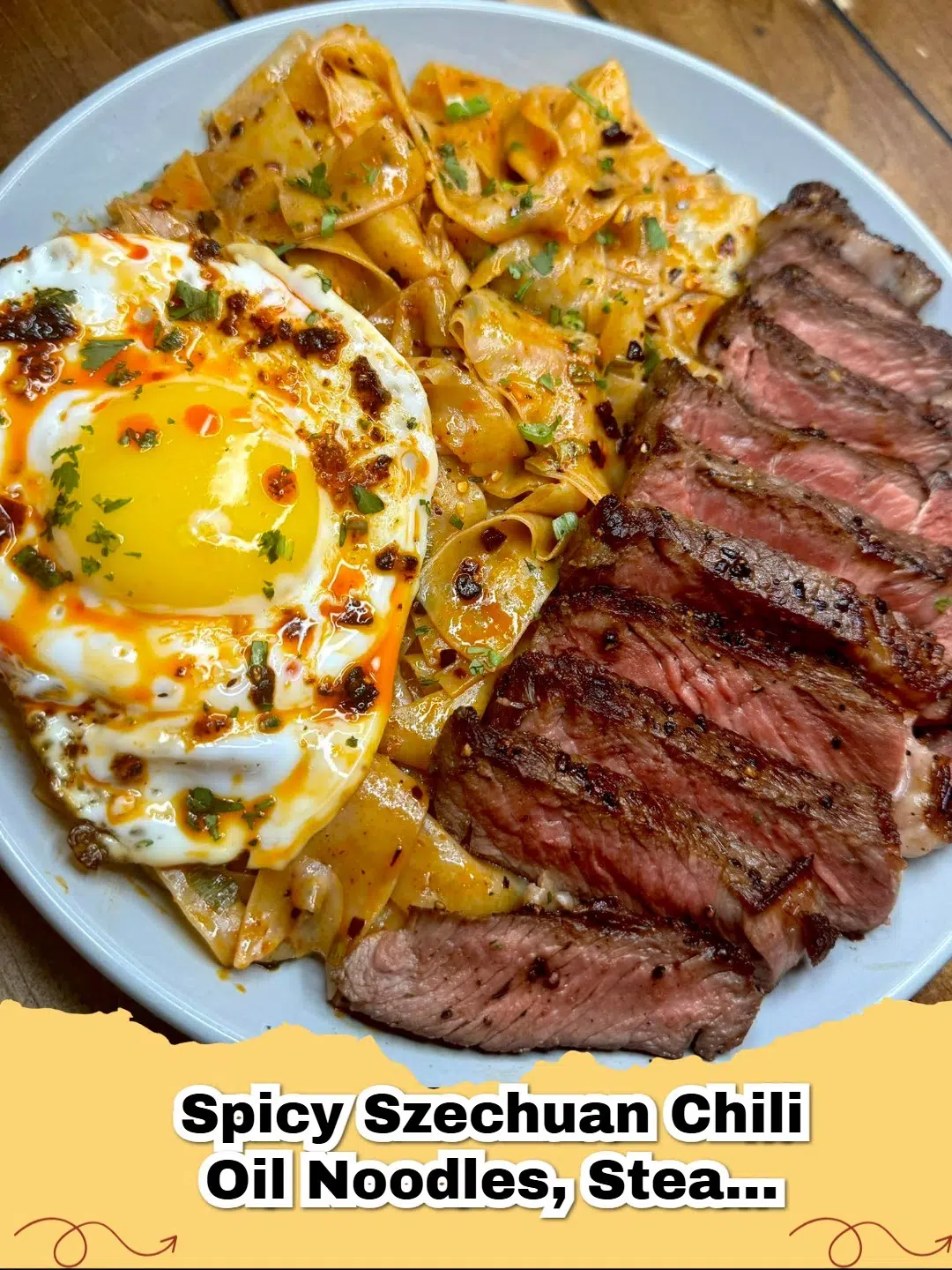 Delicious spicy Szechuan chili oil noodles with seared steak and a fried egg on top.