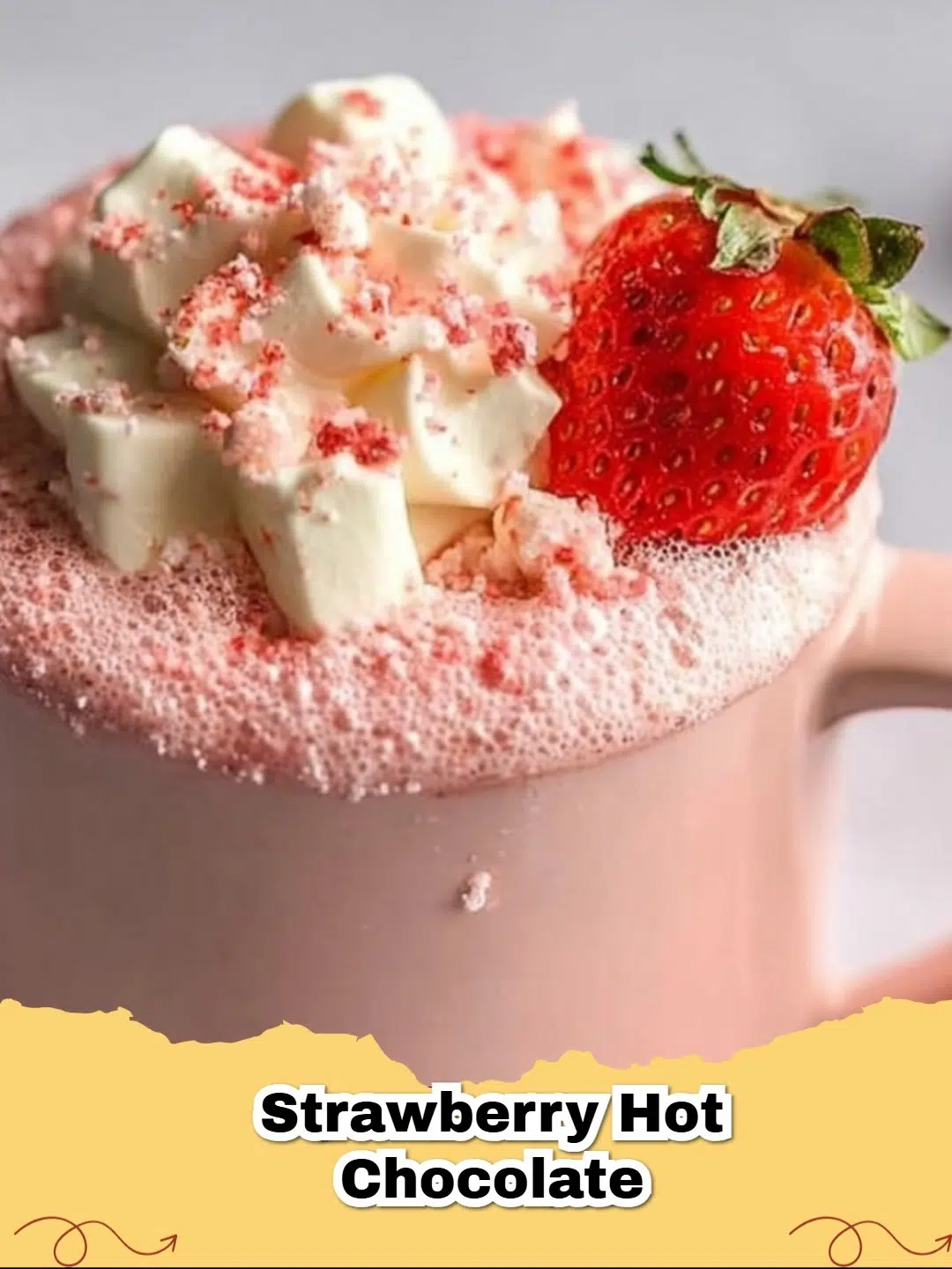 A mug of creamy Strawberry White Chocolate Hot Chocolate topped with whipped cream, fresh strawberries, and white chocolate shavings.