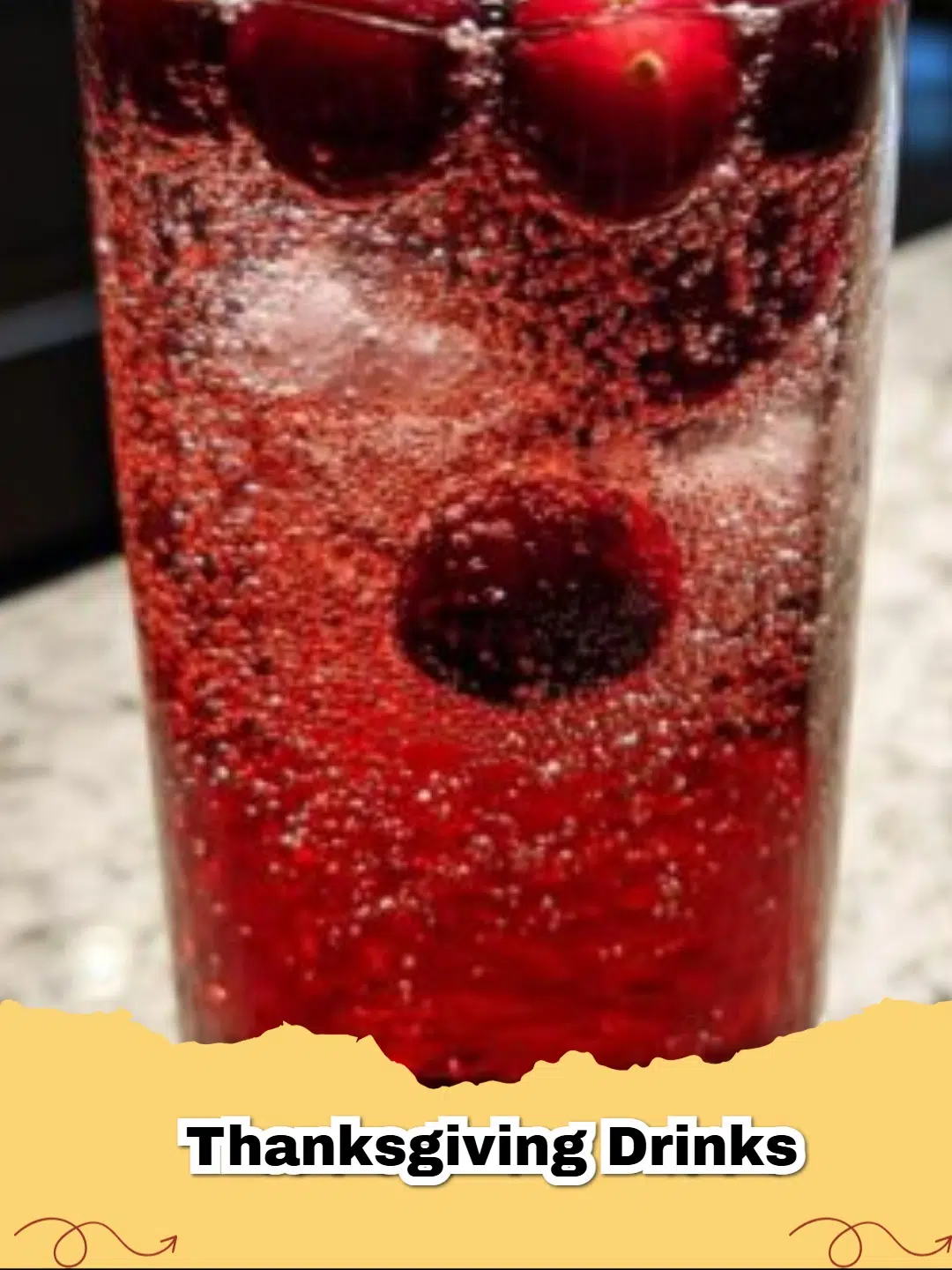 Refreshing Thanksgiving Cranberry Sparkler with fresh cranberries and rosemary garnish in an elegant glass.