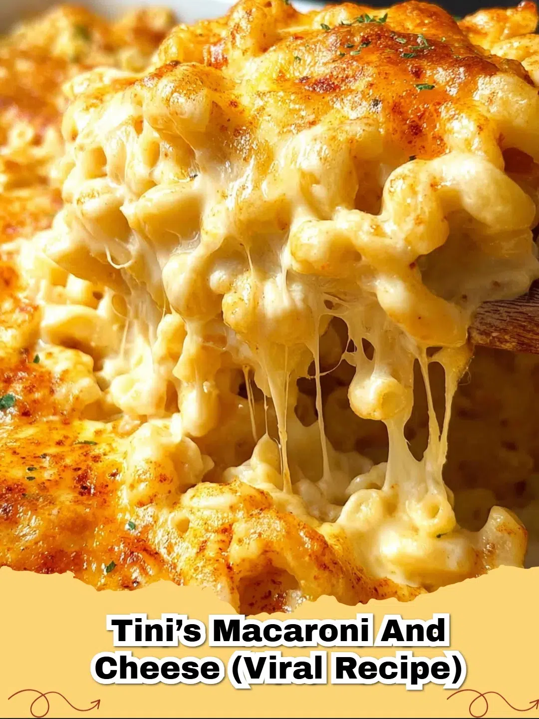A close-up of golden, bubbling Tini's Viral Creamy Macaroni and Cheese in a baking dish, garnished with fresh parsley.
