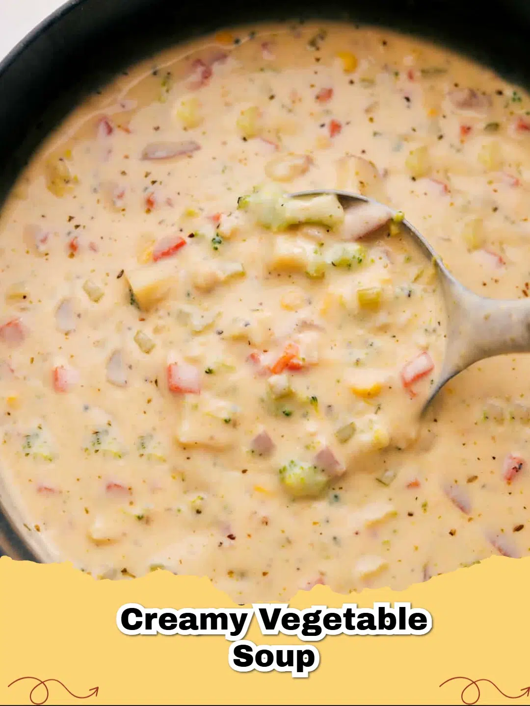 A close-up shot of a steaming bowl of homemade creamy vegetable soup, garnished with fresh parsley and a swirl of cream.