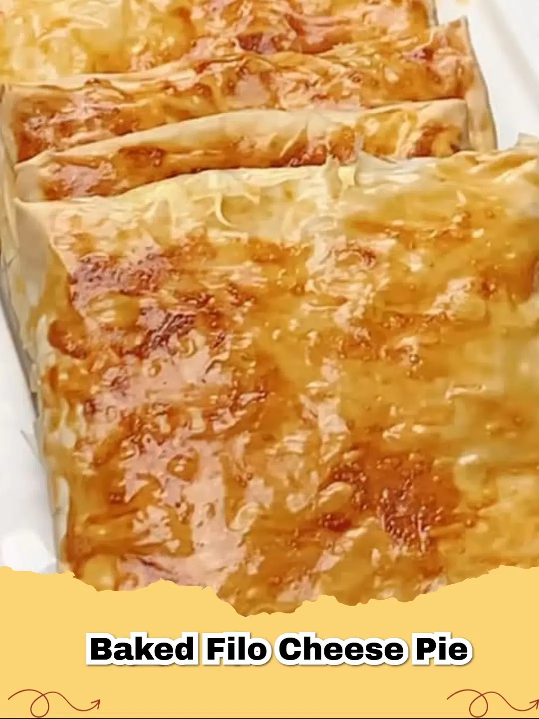 Golden brown, flaky Tiropita (Greek Cheese Pie) fresh from the oven, garnished with parsley.