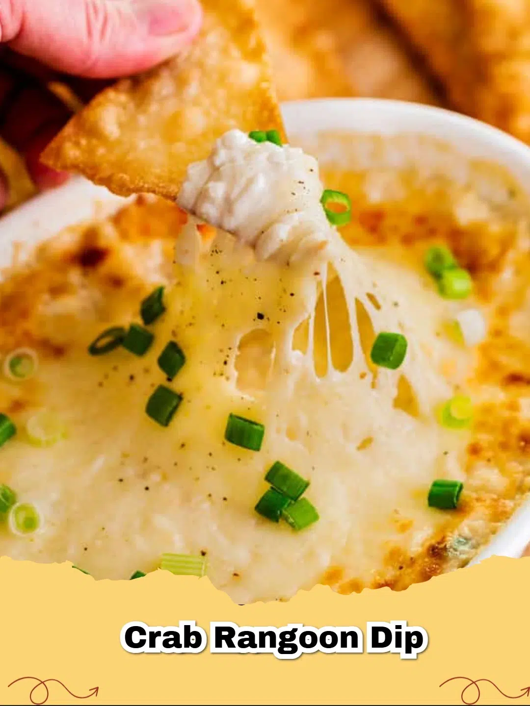 Delicious Baked Crab Rangoon Dip with golden crispy wonton chips ready for dipping.