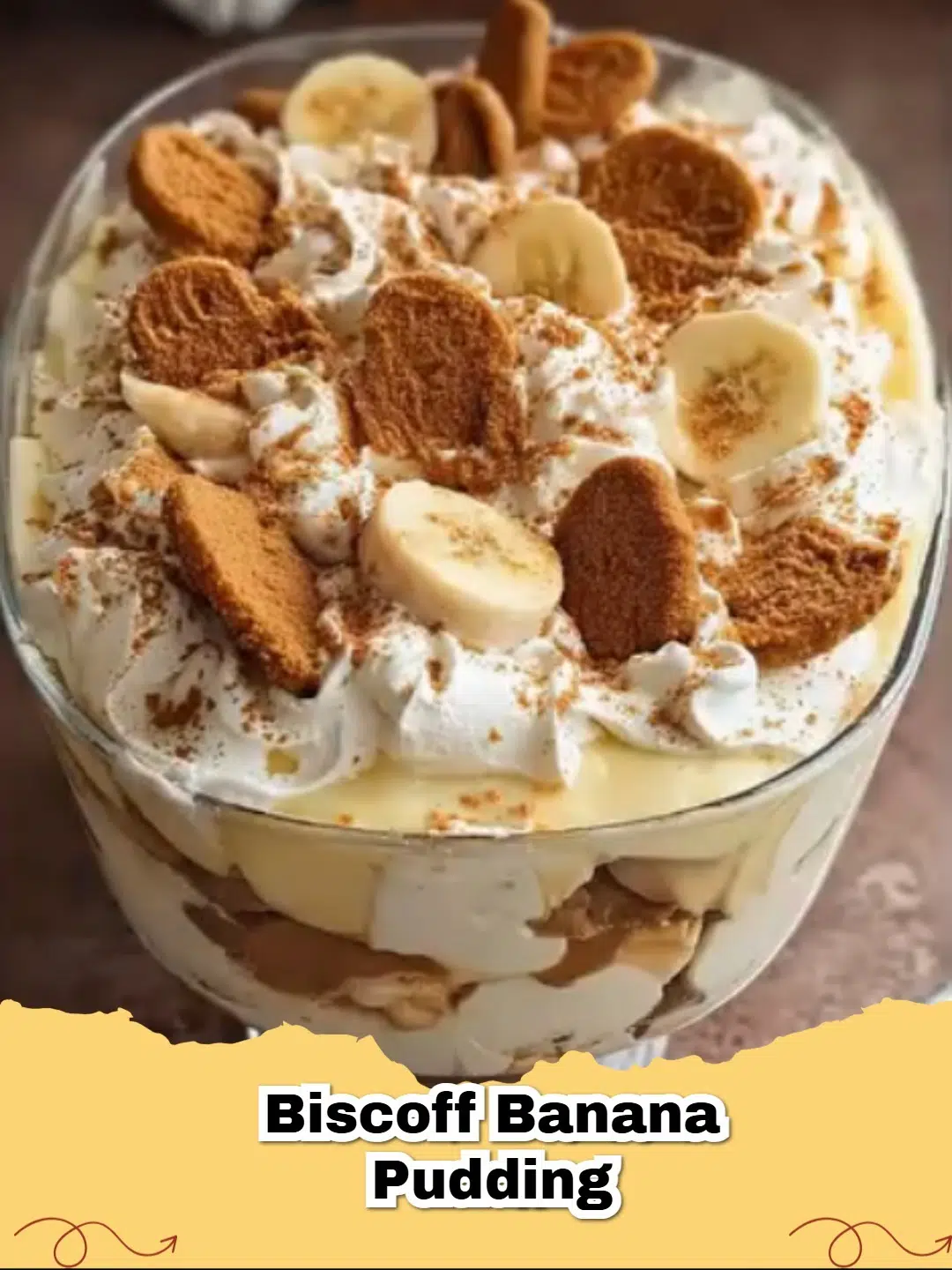 Decadent Biscoff Banana Pudding layered in a trifle dish, with crumbled Biscoff cookies and banana slices on top.