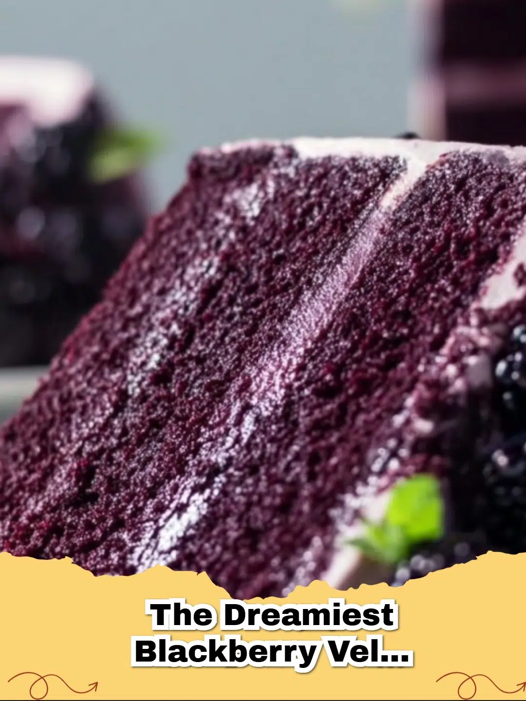 Vibrant slice of Blackberry Velvet Cake with creamy white frosting and fresh blackberries.