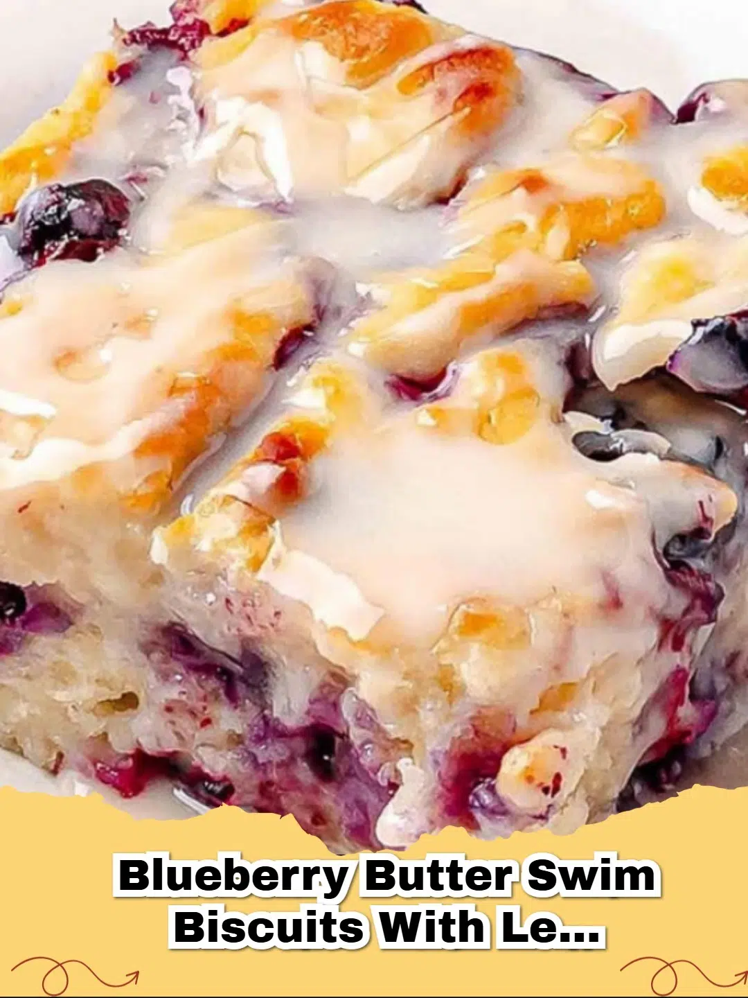 Delicious Blueberry Butter Swim Biscuits drizzled with lemon glaze, served on a white plate.
