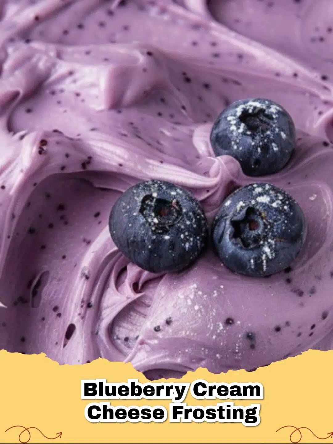 Close-up of vibrant purple Blueberry Cream Cheese Frosting piped on a vanilla cupcake.