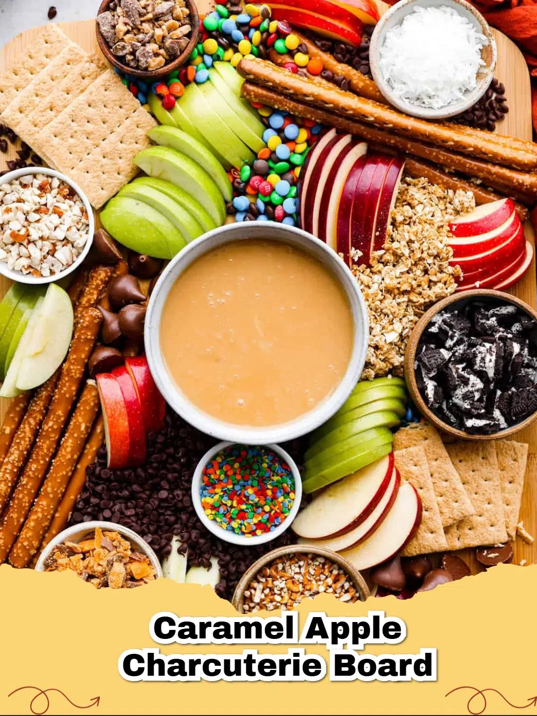 A vibrant Caramel Apple Charcuterie Board overflowing with sliced apples, creamy caramel dip, and a variety of colorful toppings, perfect for fall entertaining.