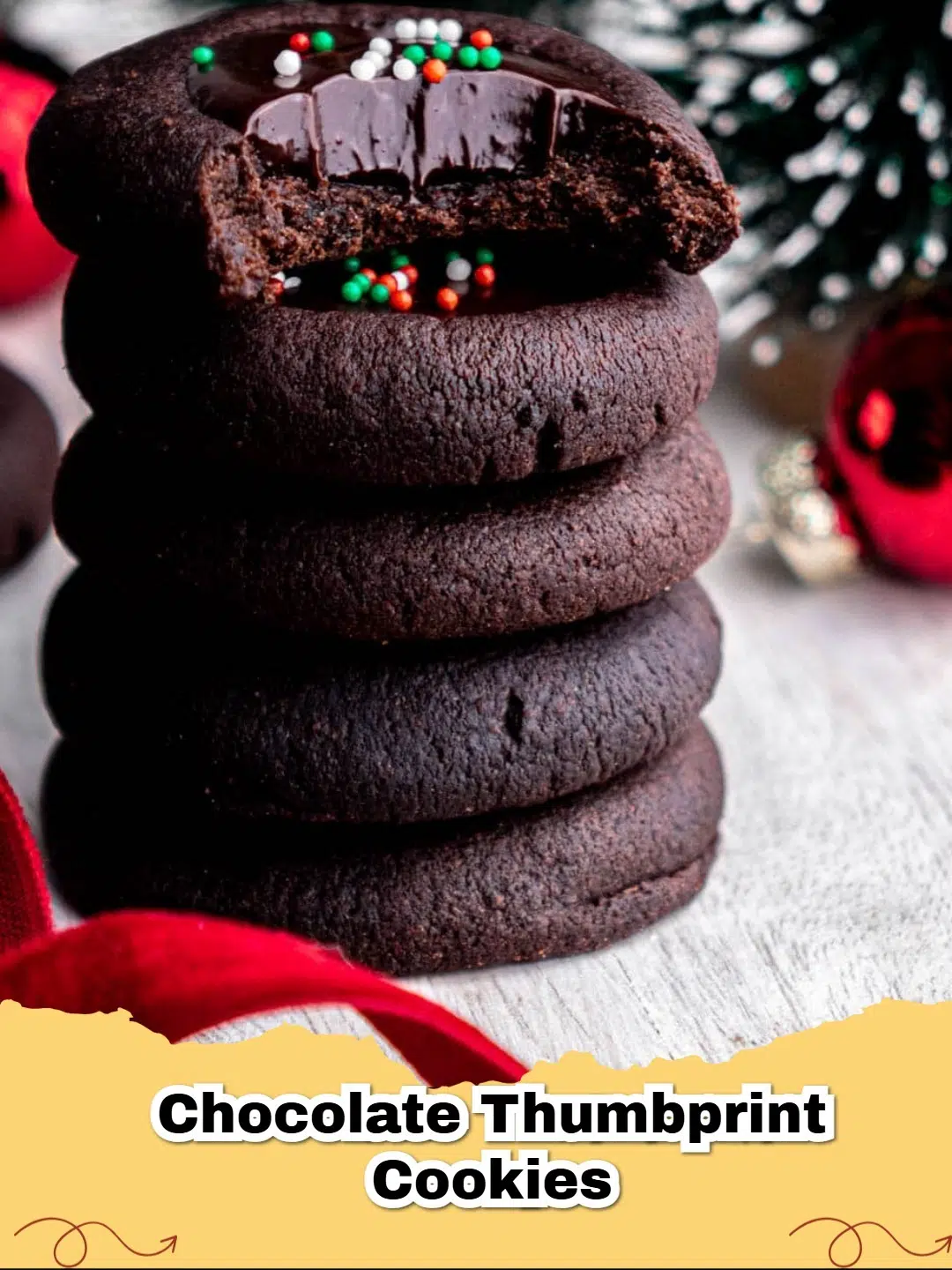 Close-up of freshly baked Chocolate Ganache Thumbprint Cookies on a cooling rack, sprinkled with nonpareils.