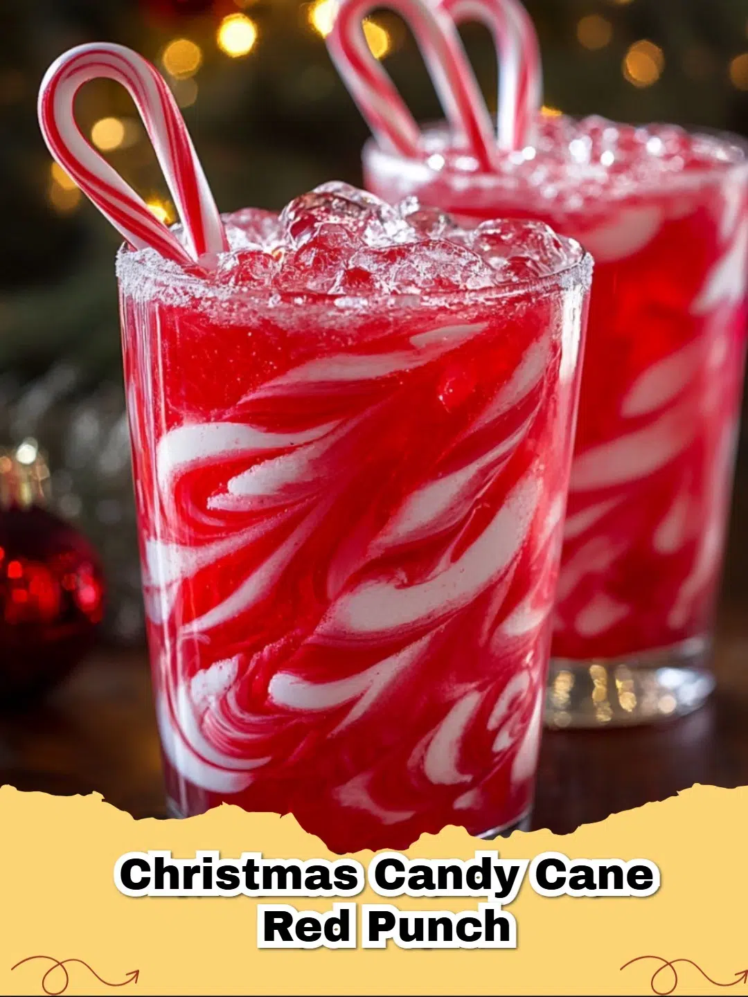 A festive red Christmas Candy Cane Punch in a glass with a sugared rim, garnished with a candy cane and fresh cranberries.