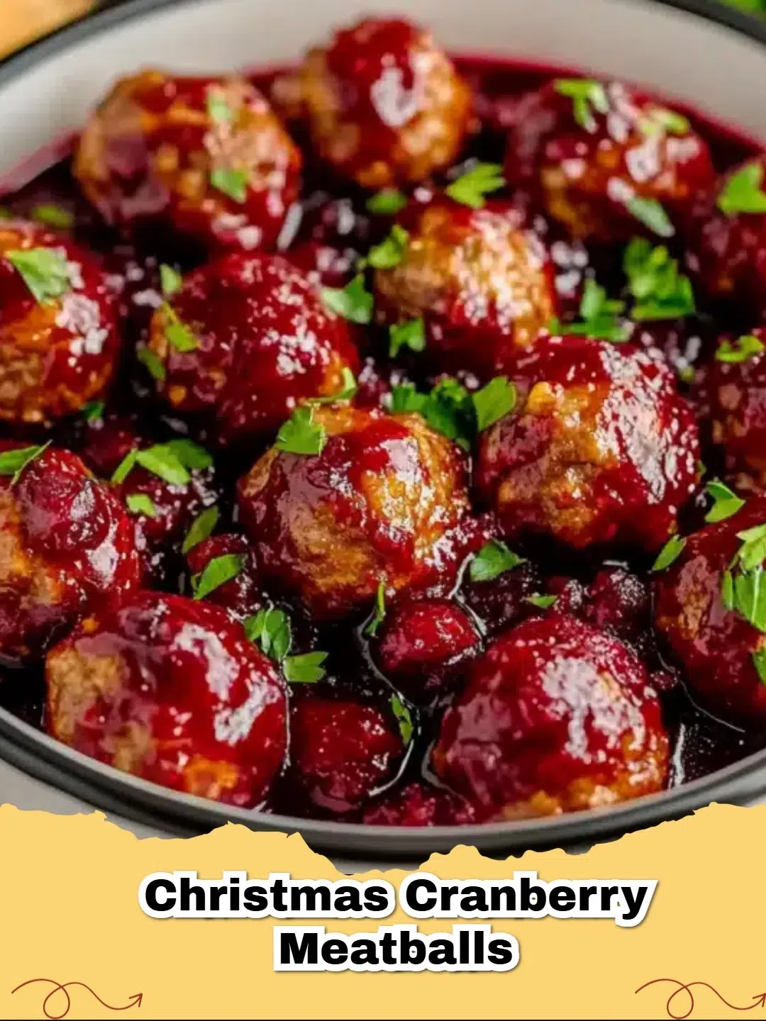 Platter of festive Christmas Cranberry Meatballs garnished with fresh rosemary and orange zest, ready for a holiday party