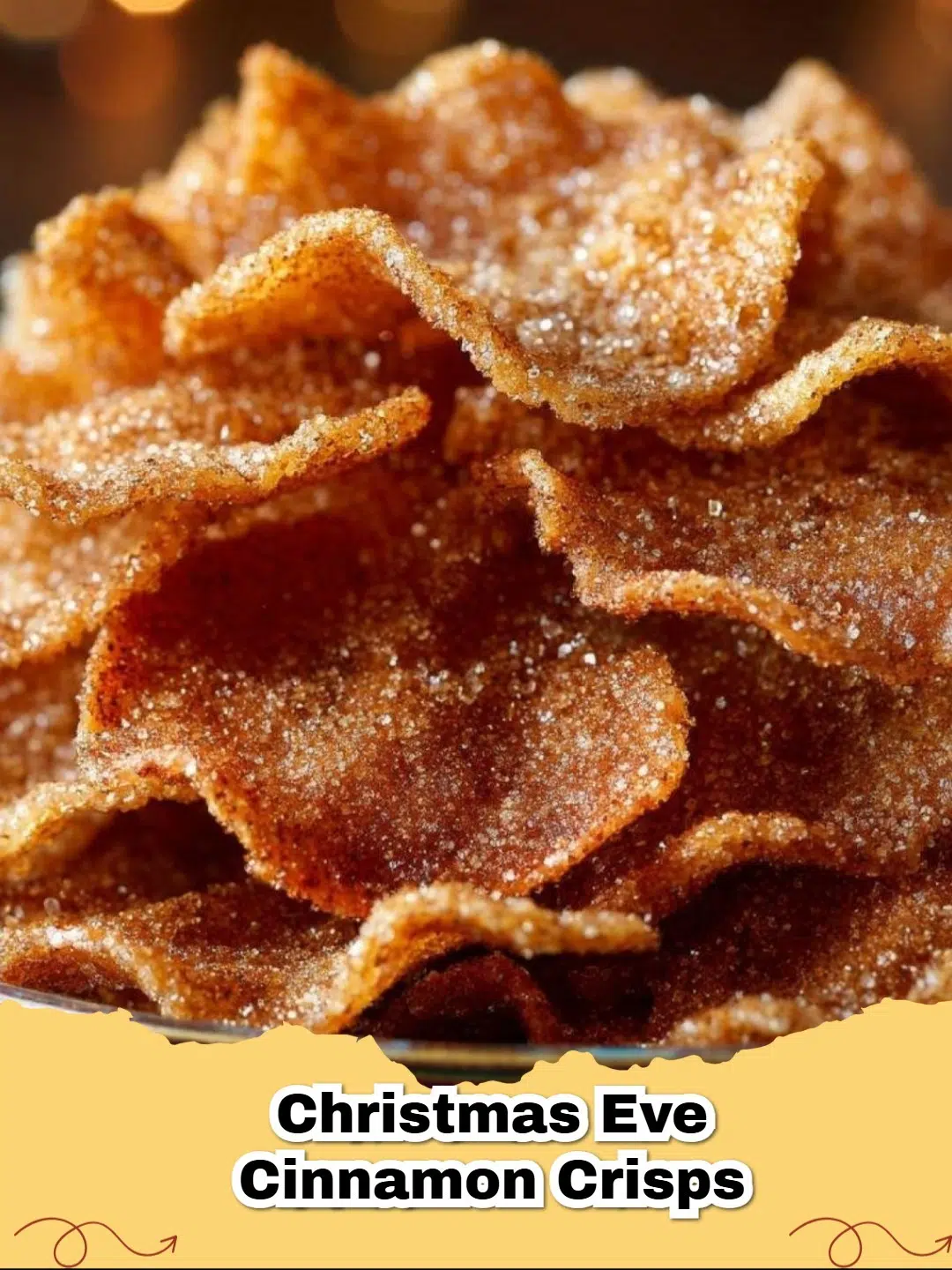 Golden brown Christmas Eve Cinnamon Crisps sprinkled with sparkling sugar on a festive plate.