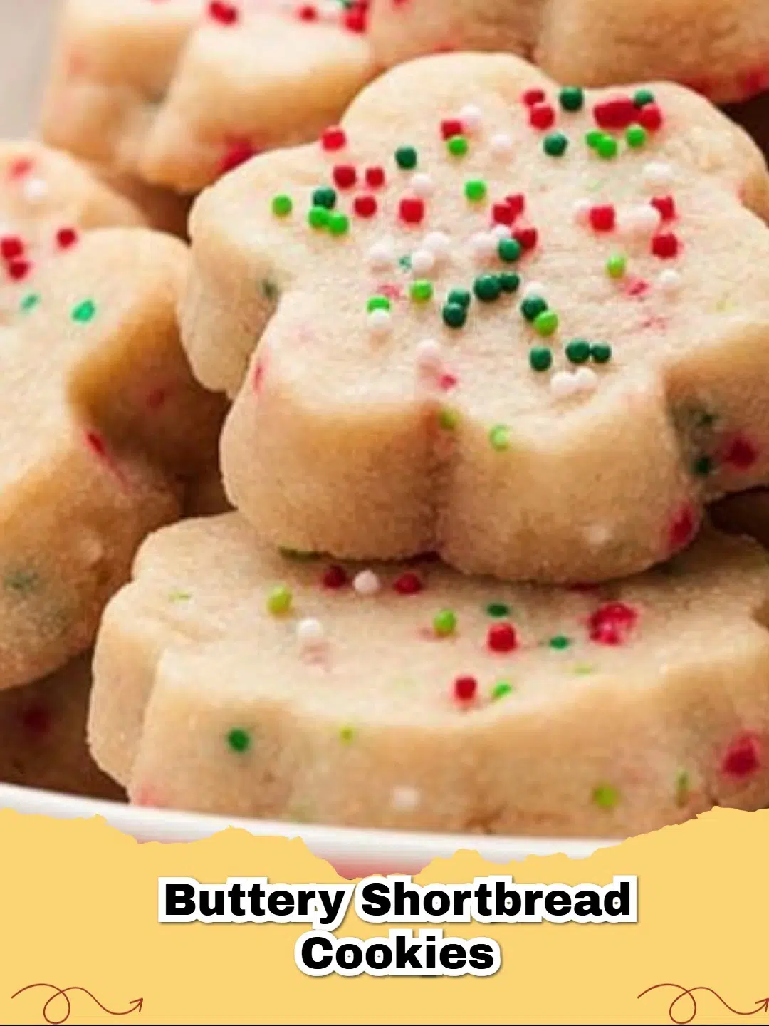 Delicious classic buttery shortbread cookies stacked on a white plate with crumbs.