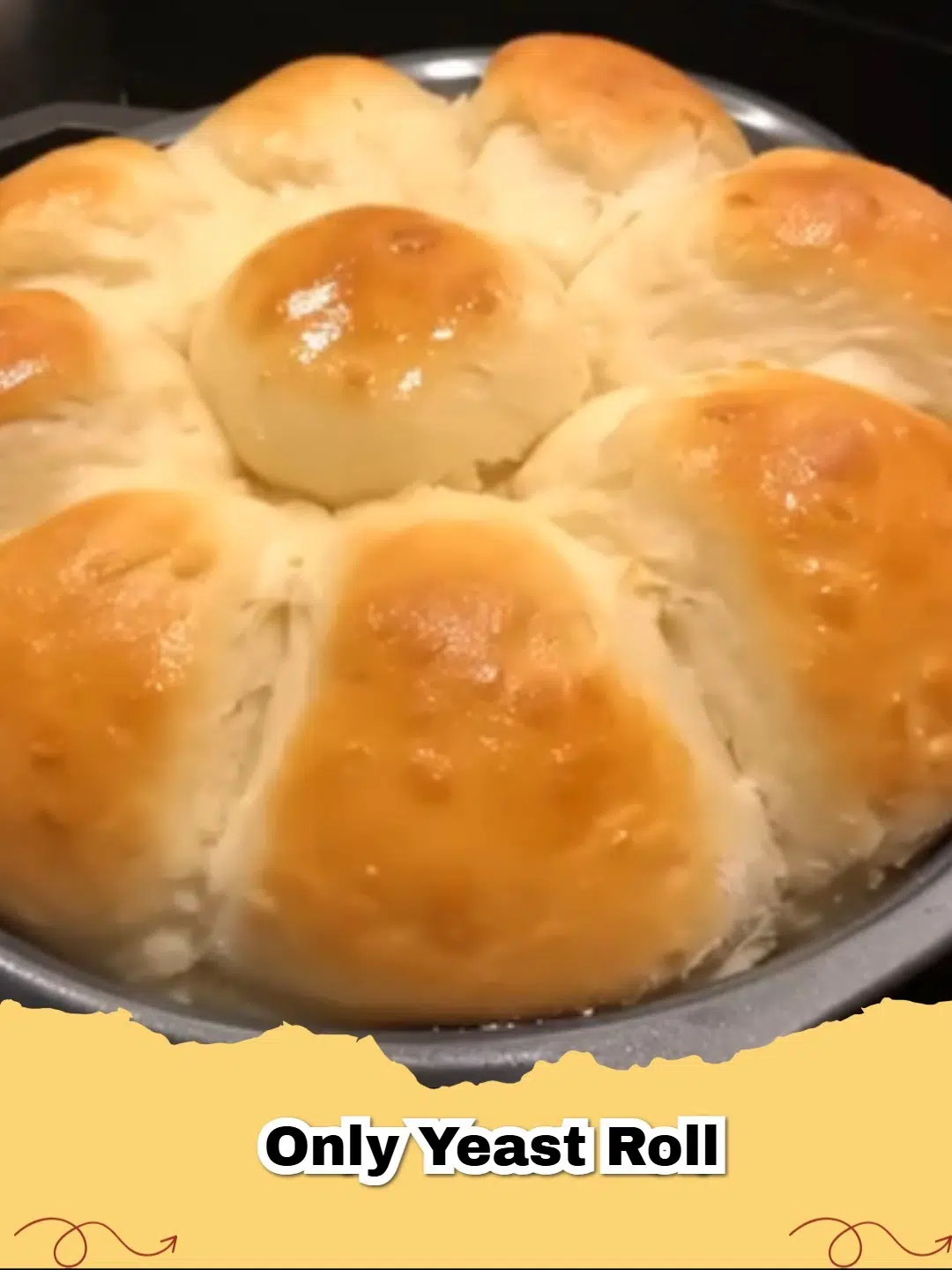 Close-up of golden brown, fluffy homemade yeast rolls in a baking dish, brushed with butter.