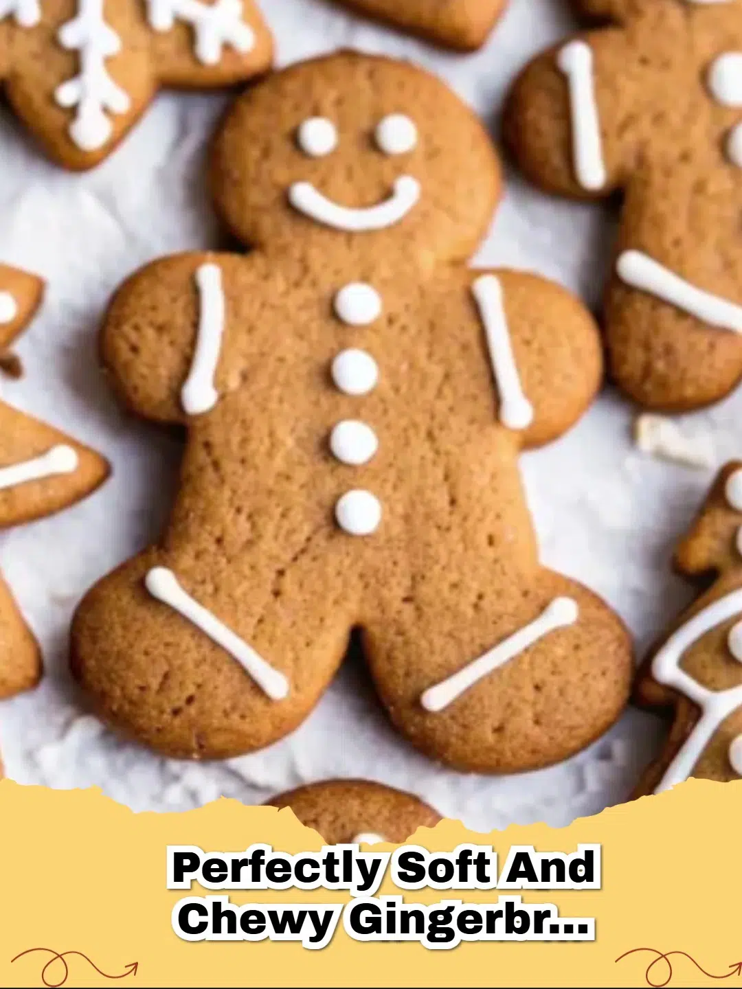 A close-up of beautifully decorated classic soft and chewy gingerbread cut-out cookies on a wooden surface, ready for the holidays.