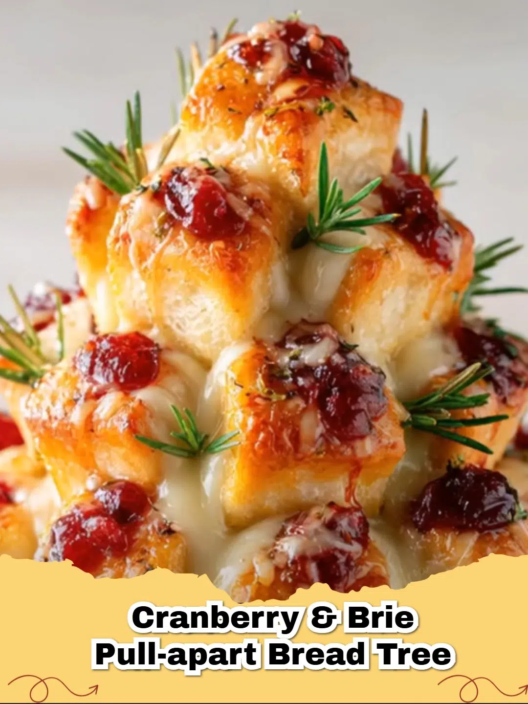 Cranberry Brie Pull-Apart Bread Tree on a serving platter, garnished with fresh rosemary, ready for the holidays.