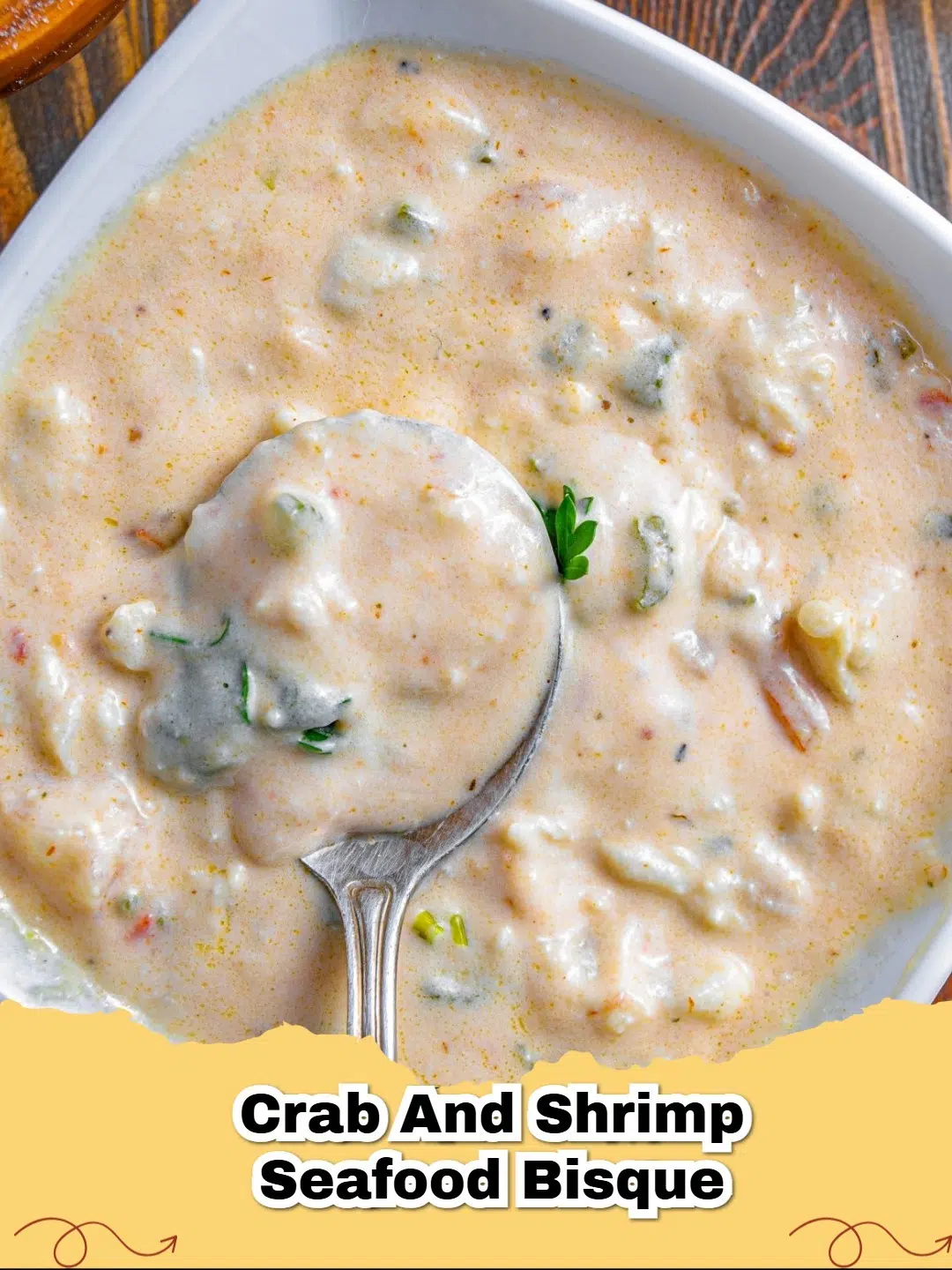 Creamy Crab and Shrimp Bisque in a bowl with crusty bread, garnished with fresh parsley.