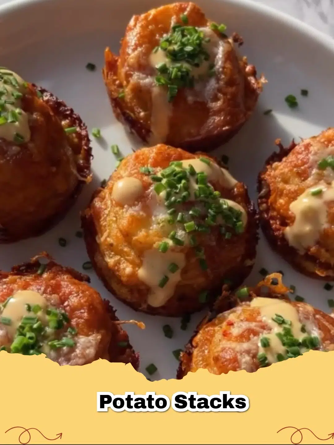 Golden brown crispy garlic herb potato stacks garnished with fresh rosemary, served on a white plate.