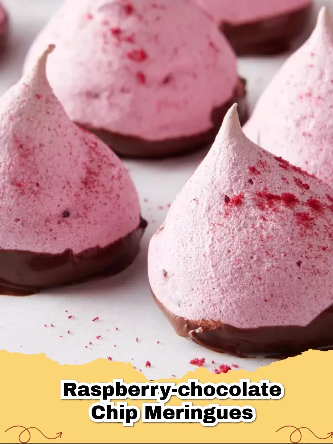 Dark Chocolate Dipped Raspberry Chocolate Chip Meringue Cookies on a cooling rack