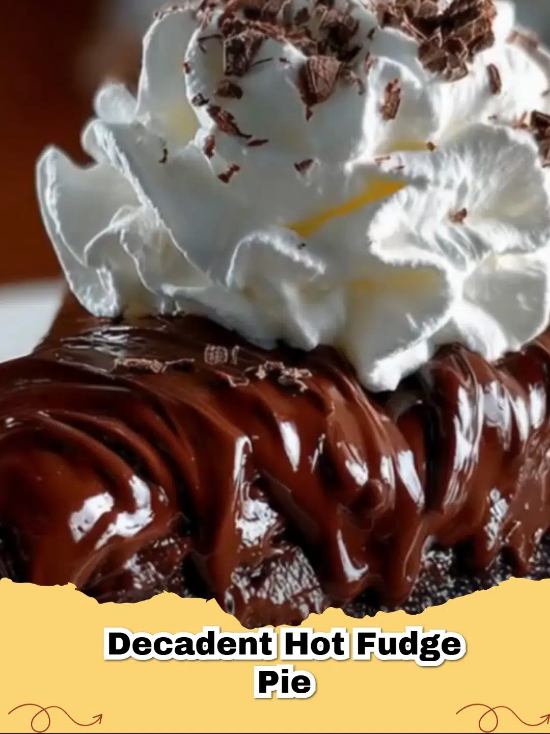 A close-up of a slice of Decadent Hot Fudge Pie topped with fluffy whipped cream and chocolate shavings, on a white plate.