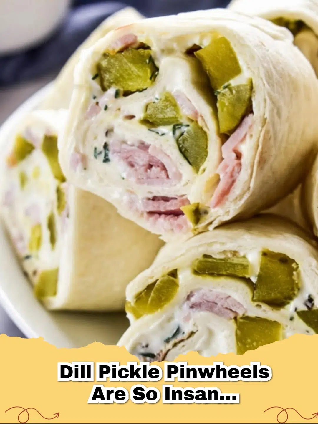 Close-up of vibrant dill pickle pinwheels arranged on a platter, showcasing the creamy filling and bright green pickle slices, perfect for an appetizer.