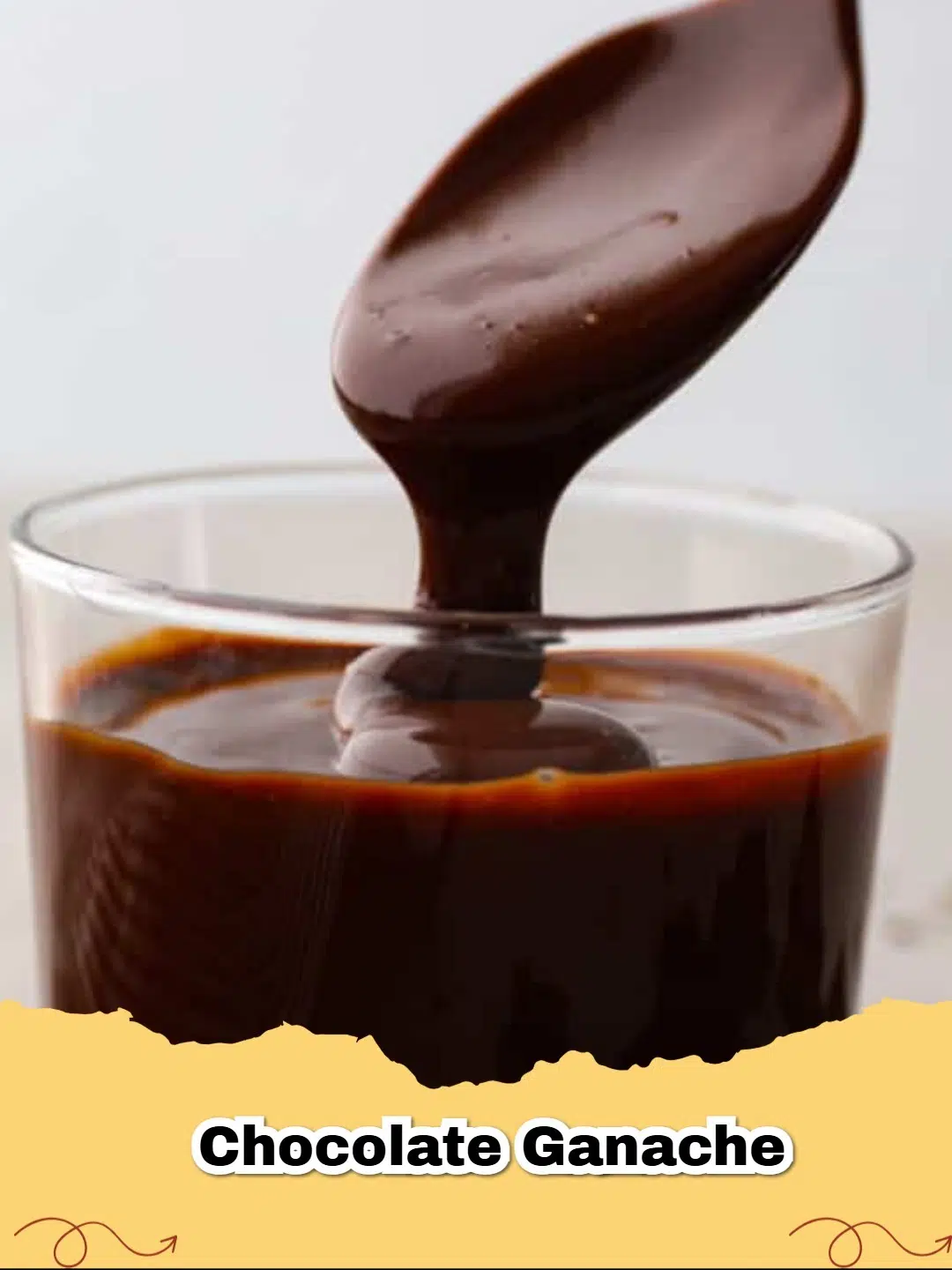 Close-up of smooth, shiny easy chocolate ganache in a white bowl with a spoon