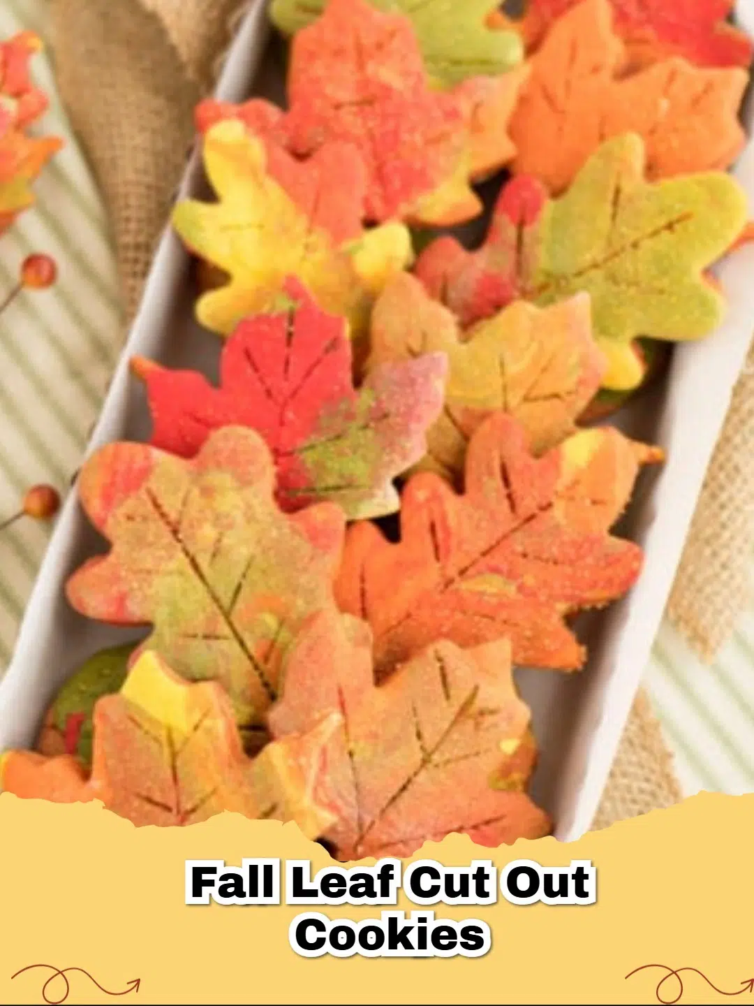 Beautifully decorated fall leaf cut out sugar cookies on a wooden board, showcasing vibrant autumn colors.