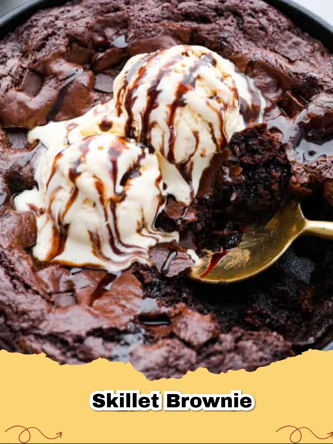 Close-up of a warm, fudgy skillet brownie served in a cast iron pan with a scoop of vanilla ice cream on top.