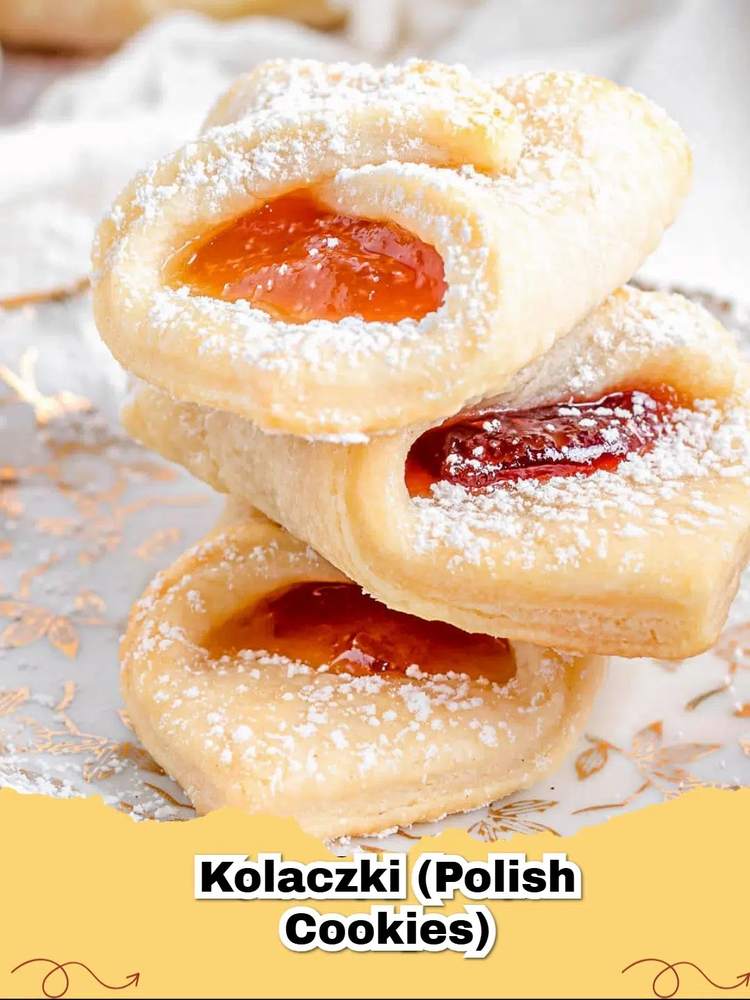 Kolaczki (Polish Cream Cheese Jam Cookies) with raspberry jam filling, dusted with powdered sugar, on a white plate.