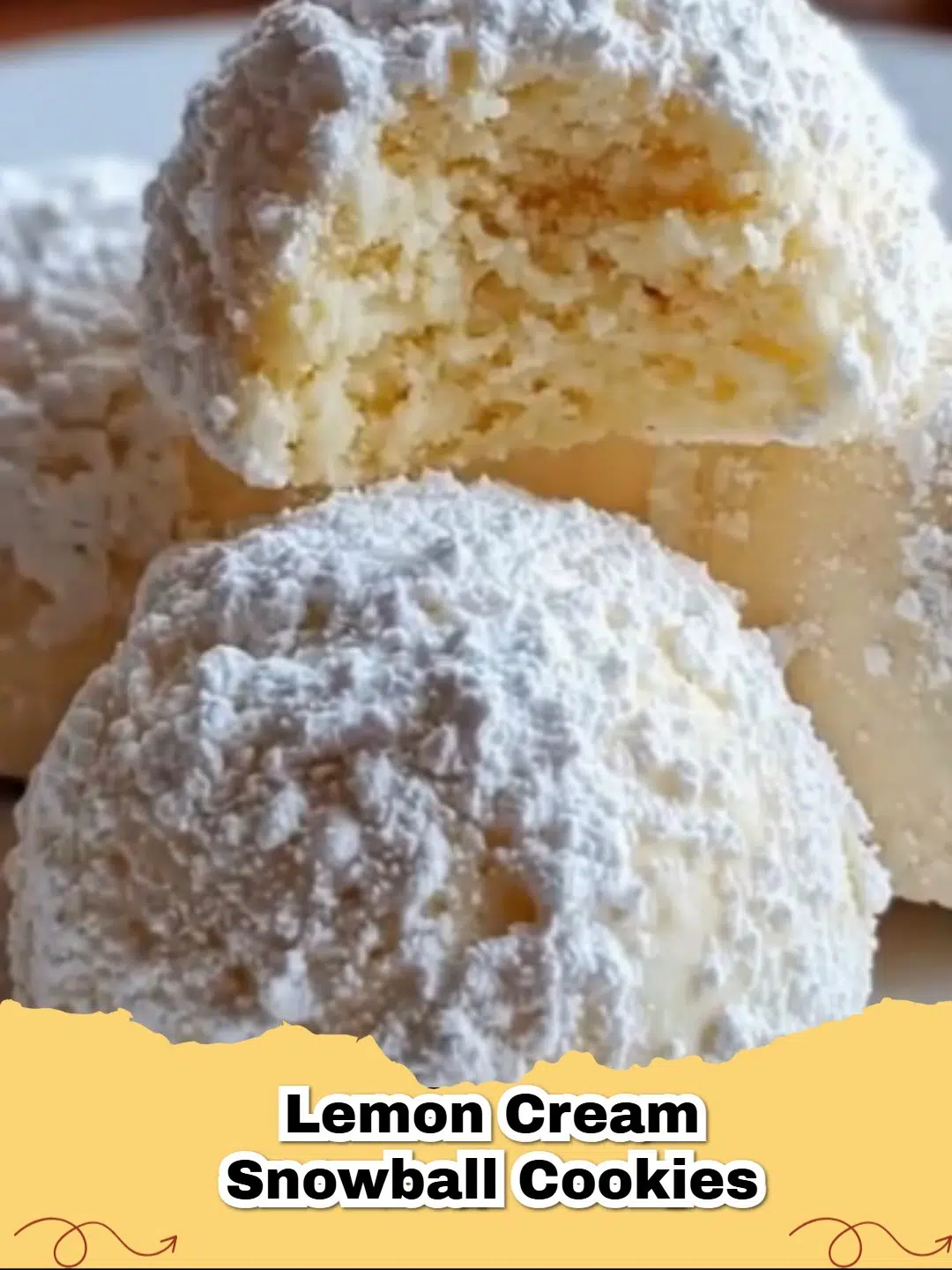 Bright and zesty Lemon Cream Snowball Cookies dusted generously with powdered sugar on a cooling rack.