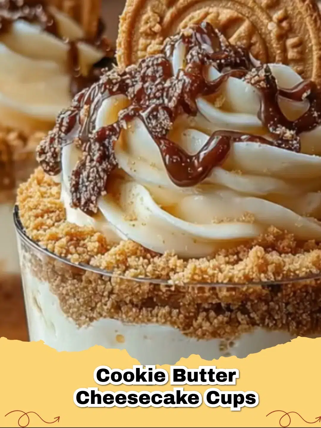 Delicious no-bake cookie butter cheesecake cups in cupcake liners, garnished with cookie crumbs.