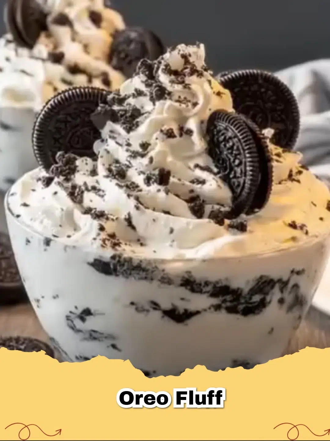 Delicious No-Bake Oreo Fluff Dessert in a glass bowl, garnished with whole Oreos and chocolate drizzle.
