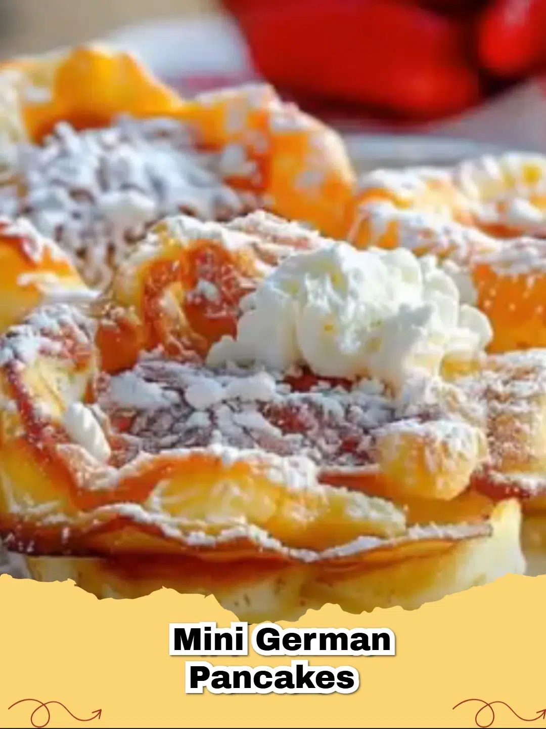 Golden brown oven-baked mini German pancakes dusted with powdered sugar and fresh berries.