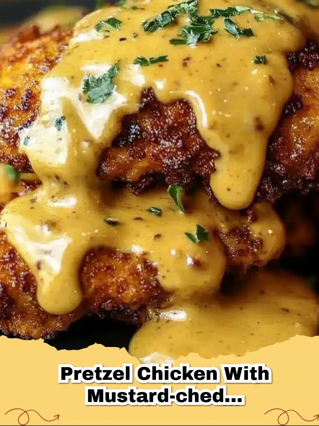 Golden brown Pretzel-Crusted Chicken breasts with creamy mustard-cheddar sauce drizzled on top, served on a plate.