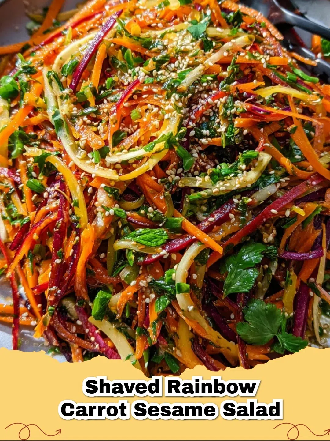 Vibrant shaved rainbow carrot sesame salad in a bowl with fresh herbs, perfect for a healthy meal.