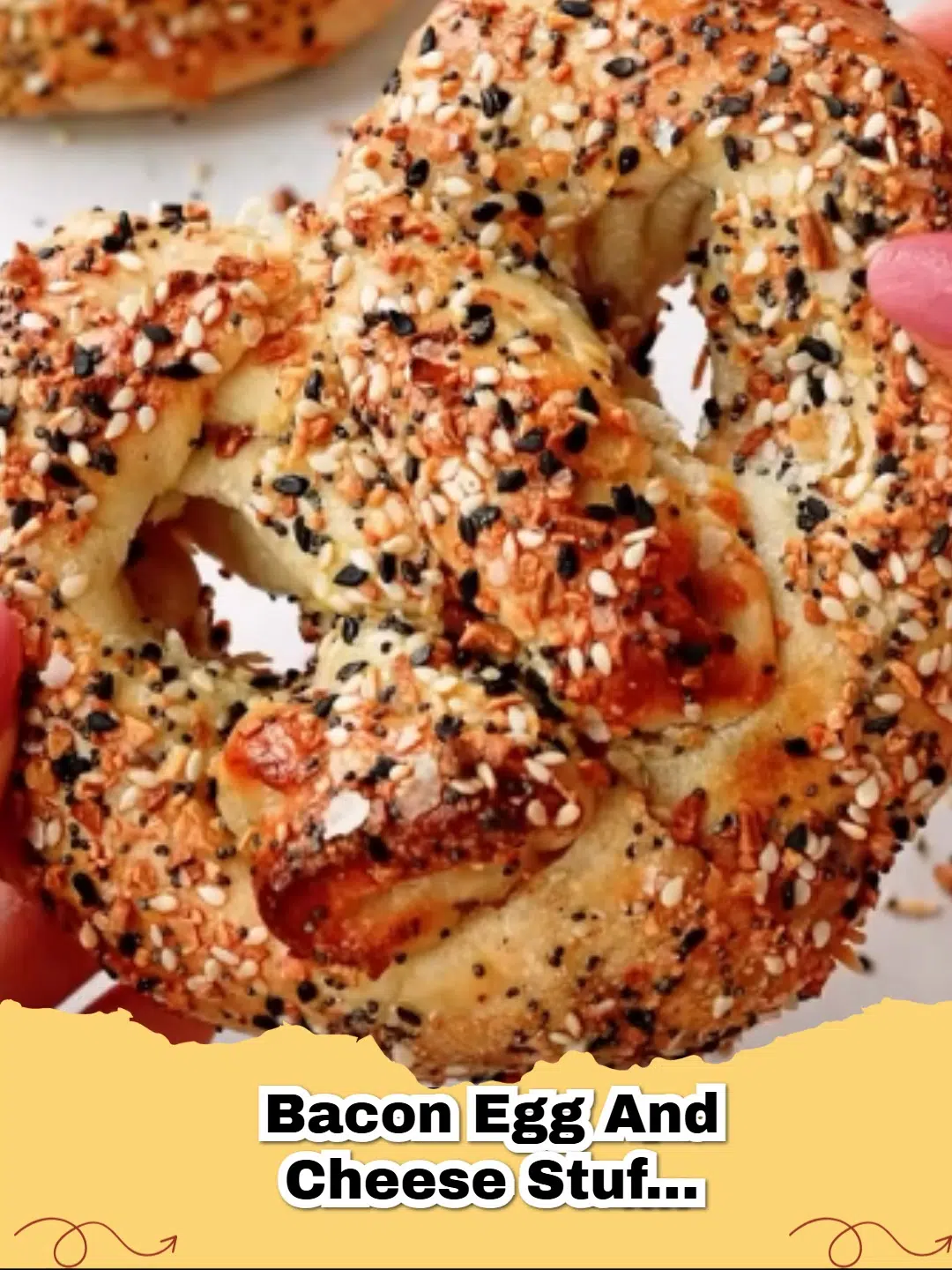 Golden brown Bacon Egg and cheese Stuffed Pretzels on a baking sheet sprinkled with salt.