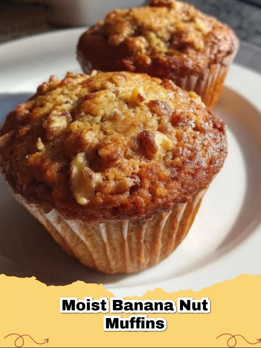 A close up shot of the Best Moist Banana Nut Muffins on a wire cooling rack with toasted walnuts on top.