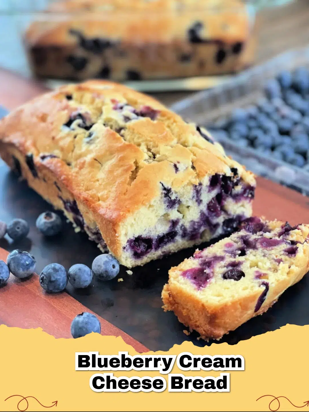 A thick slice of Blueberry Cream Cheese Bread showing juicy berries and a moist crumb.