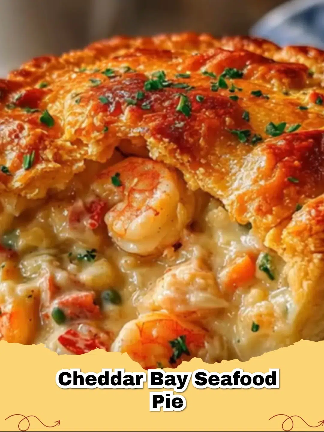 Close-up of a golden-brown Cheddar Bay Seafood Pie with a cheesy biscuit topping and visible seafood filling.