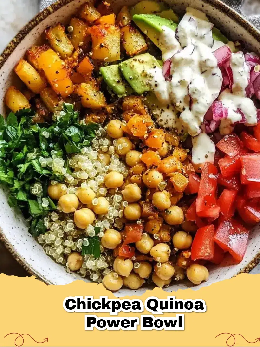 A vibrant Chickpea, Avocado, and Quinoa Summer Bowl topped with fresh parsley and lemon wedges