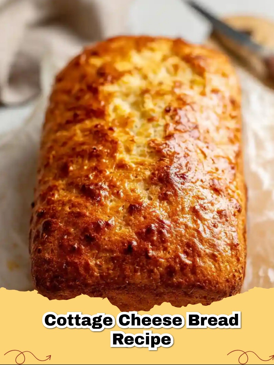 A golden-brown loaf of Easy High-Protein Cottage Cheese Bread sliced on a wooden board.