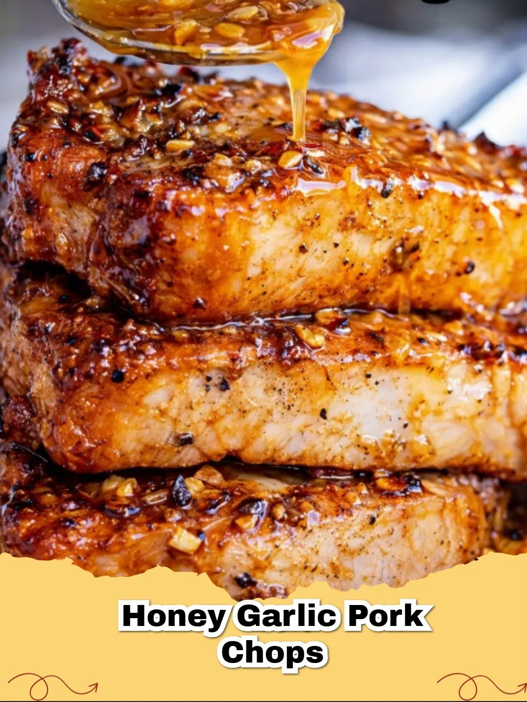 A plate of Easy Honey Garlic Pork Chops with a glistening golden glaze and fresh herbs.